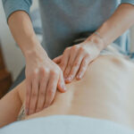 A massage therapist rubbing a client's back