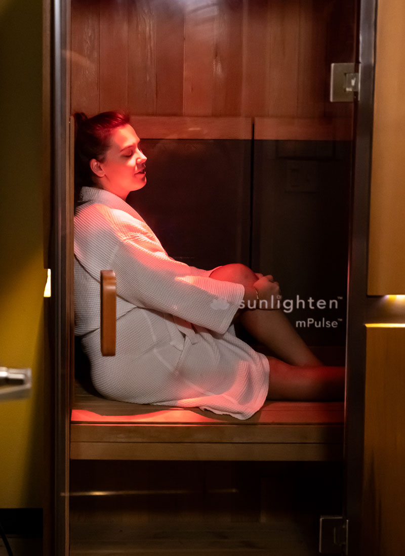 The infrared sauna at Nearing Total Health with a person relaxing inside